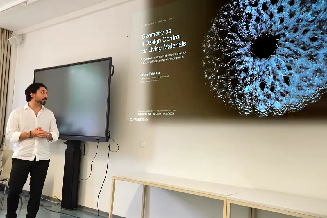Raffaele beside the projected title slide, Geometry as a Design Control for Living Materials