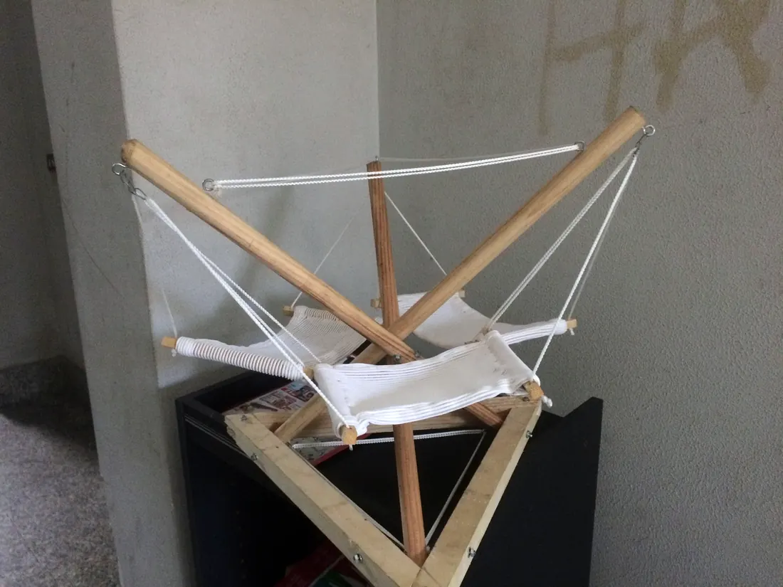Table-top model of the frame: wooden sticks, string and three canvas seats