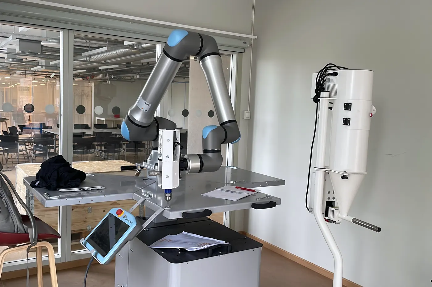 A UR15 robot arm fitted with a paste extruder, in the Material Practices Lab