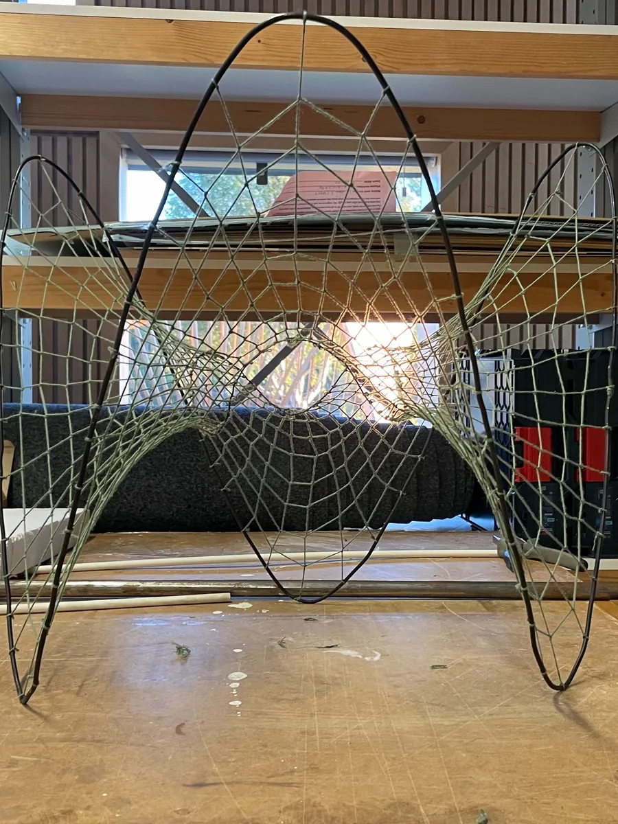 MK3 in the workshop: bent steel hoops carrying a rope net