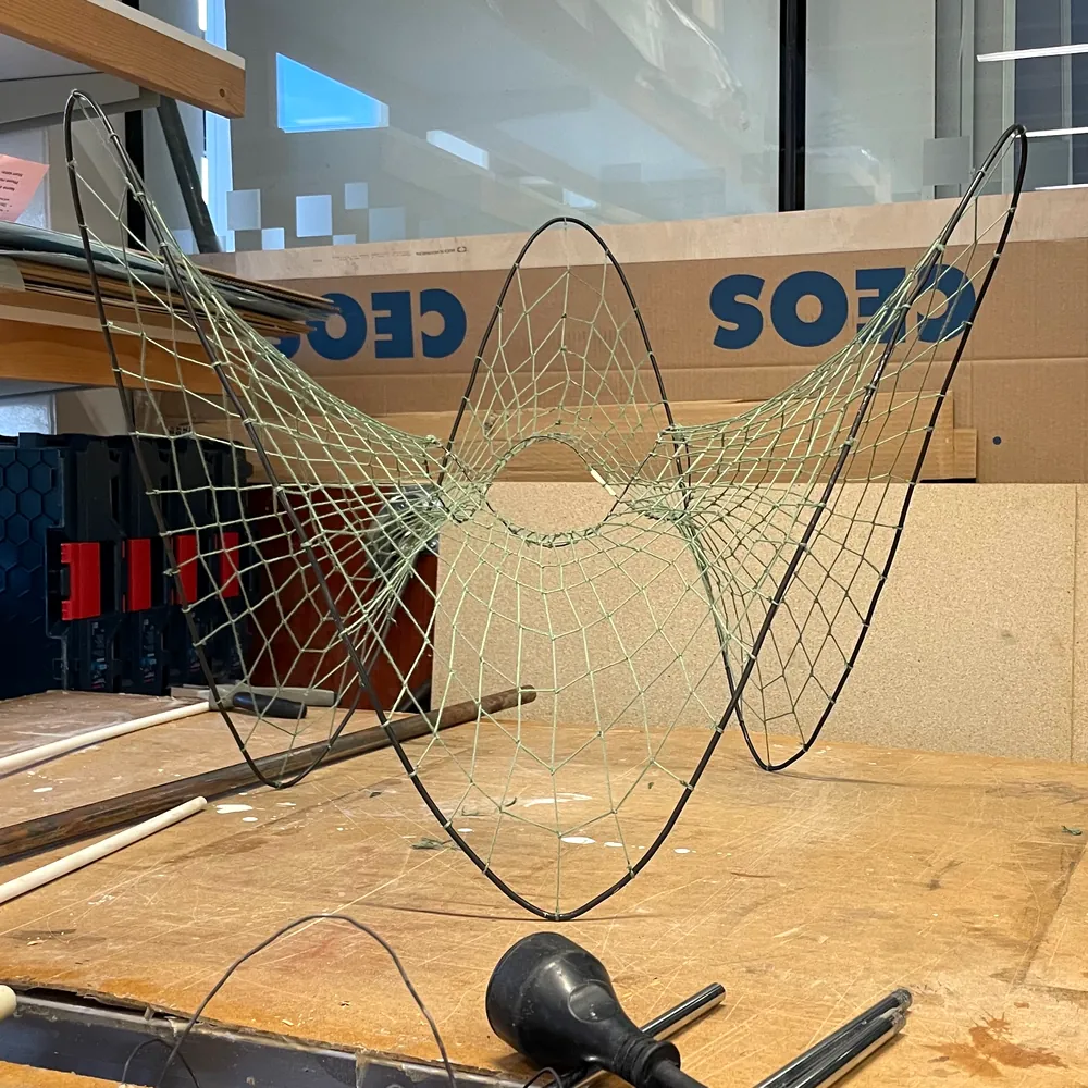 MK3 on the workbench: bent steel hoops with a rope net drawn between them