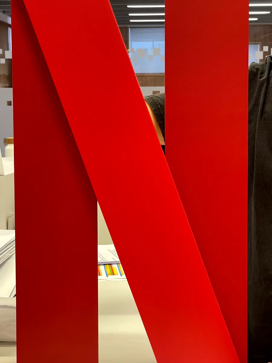 The finished red N held up in the office