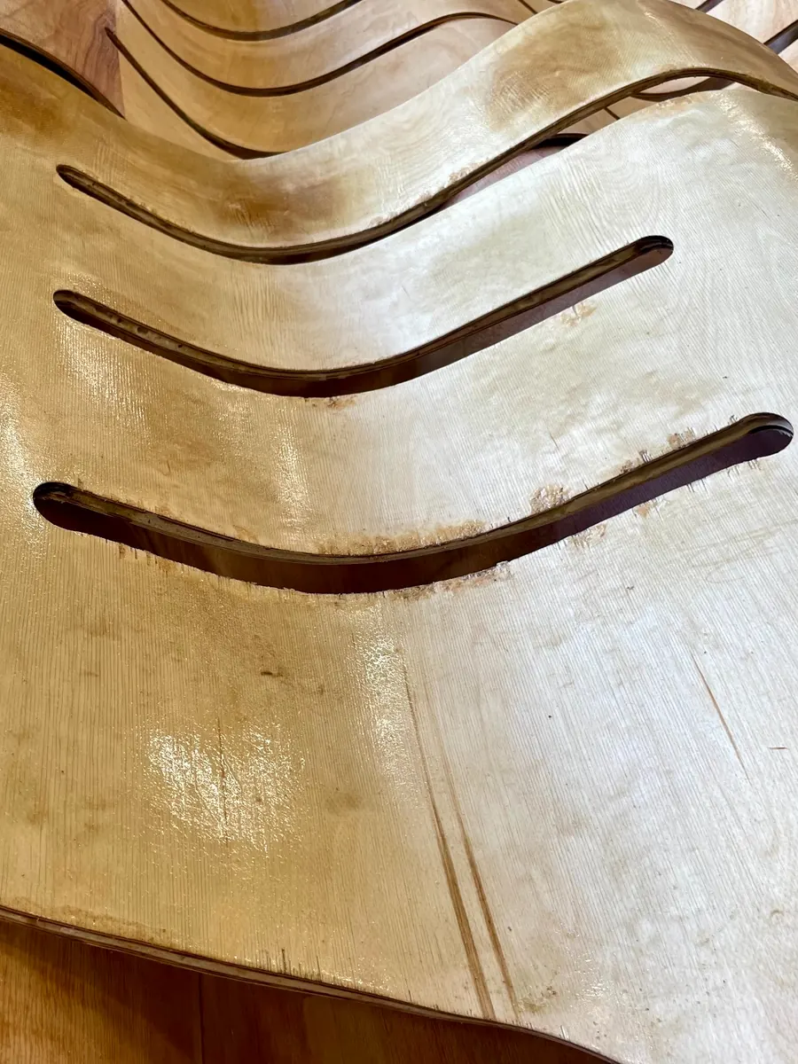 Close-up of the thin laminated wood, cut in long curving slots
