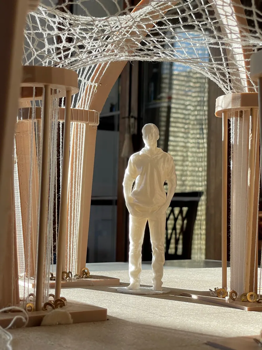 Thesis model of arches and nets with a small white figure